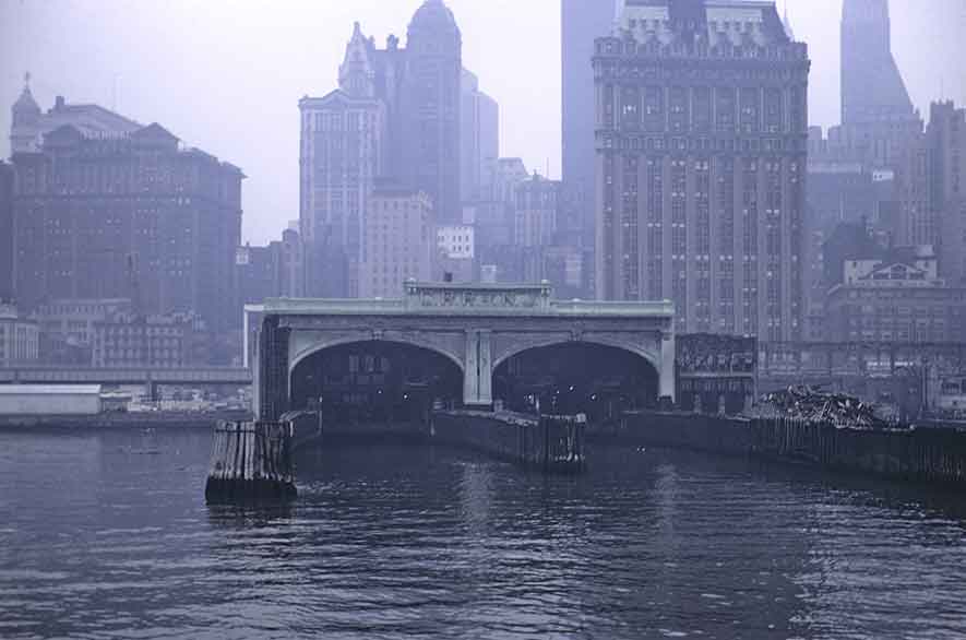 A distant picture of a ferry terminal with the city in the background