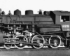 A close up black and white photo of a locomotive