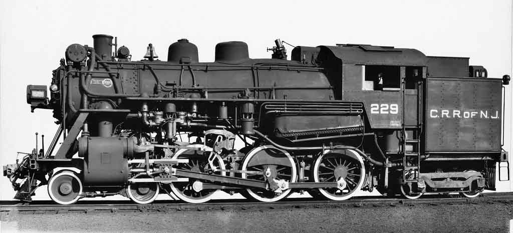 A close up black and white photo of a locomotive