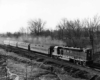 A black and white photo of a locomotive on the tracks