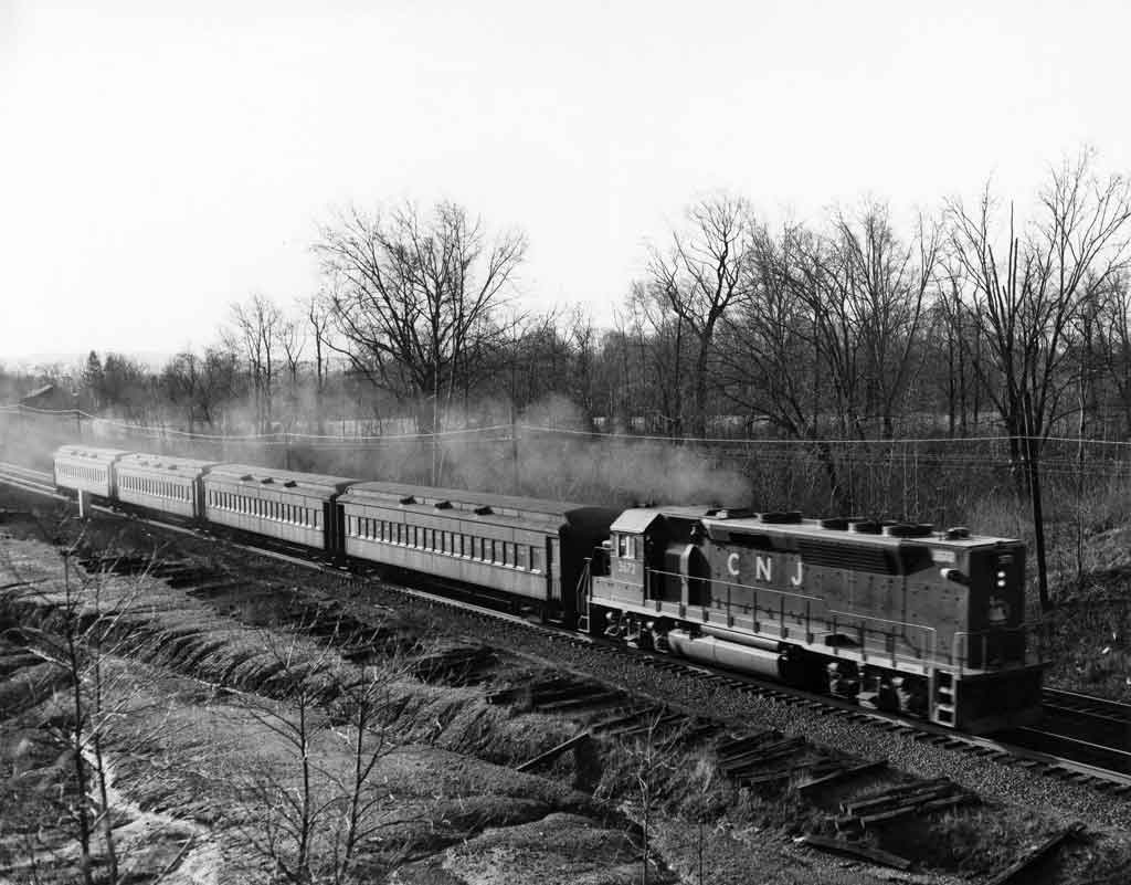 A black and white photo of a locomotive on the tracks