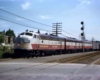 Three diesel locomotives pull passenger train by signal