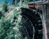 Rear of passenger train on wooden trestle