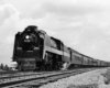 A black and white photo of a train on the tracks