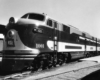 A black and white photo of a close up of a locomotive sitting on the tracks