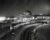 a diesel train leaving a train station at night