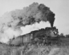 a steam engine pulling passenger cars