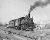 a steam engine pulling a passenger car