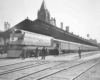 A black and white photo of passengers loading a train