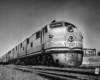 A black and white close up photo of a locomotive