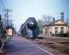 a streamlined passenger train pulling into a depot