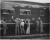 people polishing a passenger car