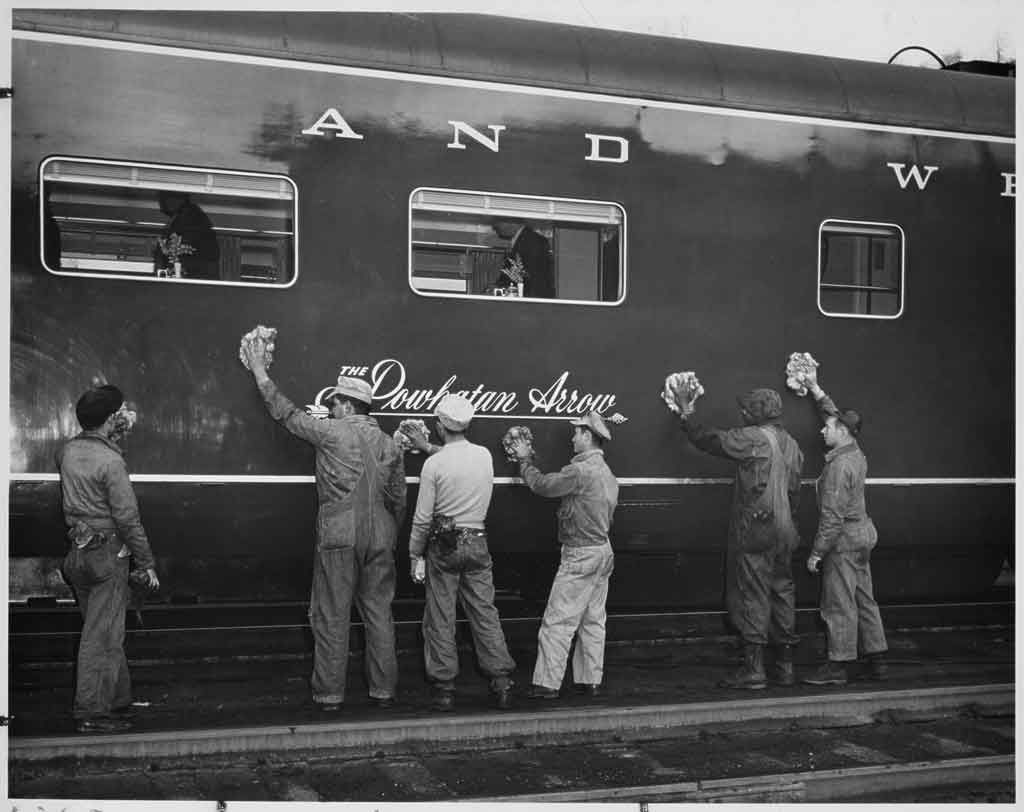 people polishing a passenger car
