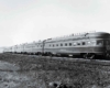 A black and white photo of a locomotive on the tracks