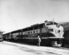 Man talks to engineer in diesel locomotive window