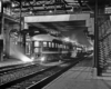 End of streamlined passenger car in station at night