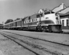 Man climbs on diesel locomotive in front of station