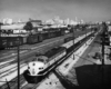 Diesel locomotive with passenger train in freight yard