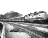 Diesel locomotive with six-car passenger train on curve