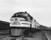 A black and white photo of a train stopped at a station