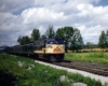 A yellow and navy blue passing through a rural area