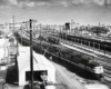 A black and white overhead photo of a handful of trains at a terminal