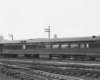 A black and white photo of a train parked on the tracks