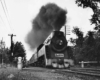 A black and white photo of a train with big black smoke coming out of its chimney