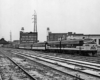 A black and white photo of a train parked at a station