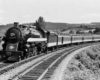 A black and white photo of a locomotive turning a corner