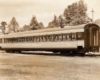 A photo of a passenger car sitting on the tracks