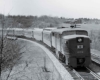 A black and white photo of a locomotive turning a corner