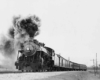 a steam engine pulling passenger cars