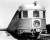 A closeup shot of a passenger train sitting on the tracks