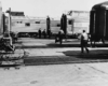 People walking by parked passenger trains