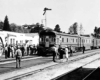 Passengers standing around a passenger train