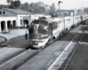 A passenger train sitting at the station waiting for passengers