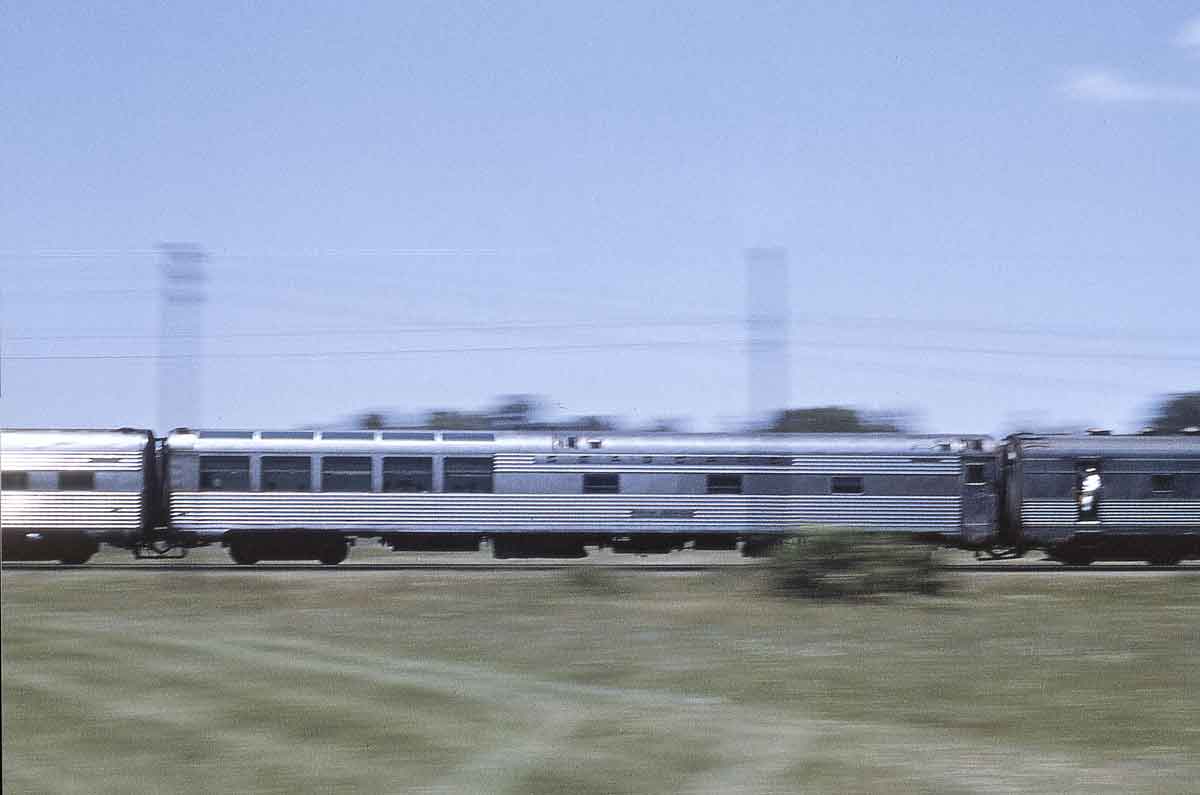 A streamline passenger train seen in a motion blurred image.