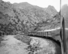 a photo of a diesel passenger train rounding a curve