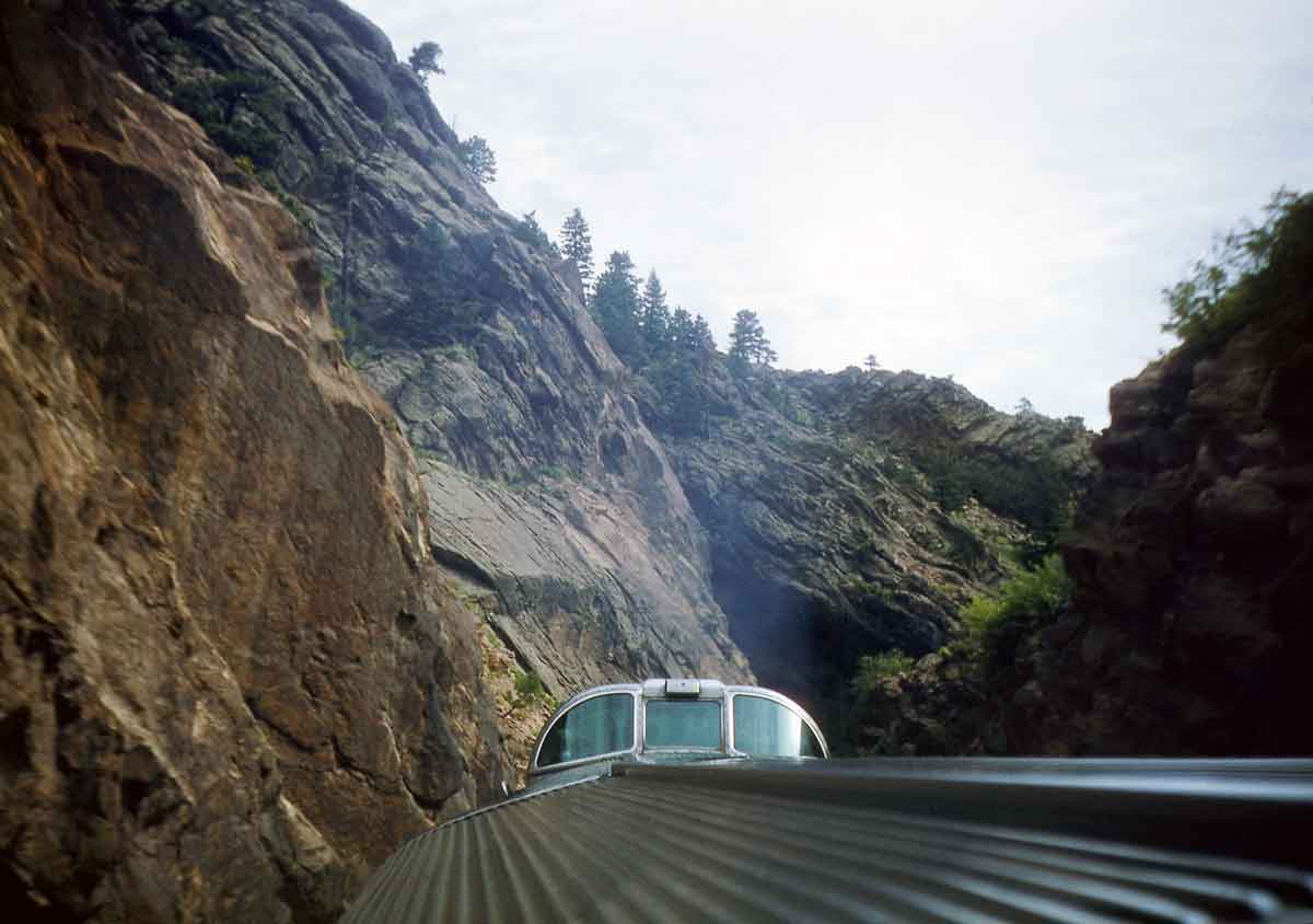 the top of an observation car in a canyon