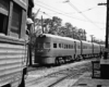 A passenger train passing a standard car