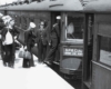 a line of sailors boarding a passenger train