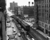 a commuter train on rails above a busy street in Chicago