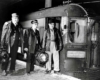 an engineer, conductor, and a third person standing by a passenger train