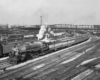 a steam engine in a train yard