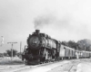 a steam engine pulling box cars