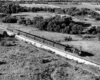 a steam engine pulling passenger cars