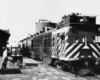 Passengers at a station loading a passenger train