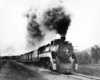 a steam engine pulling passenger cars