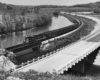 a passenger train crossing a bridge over a river